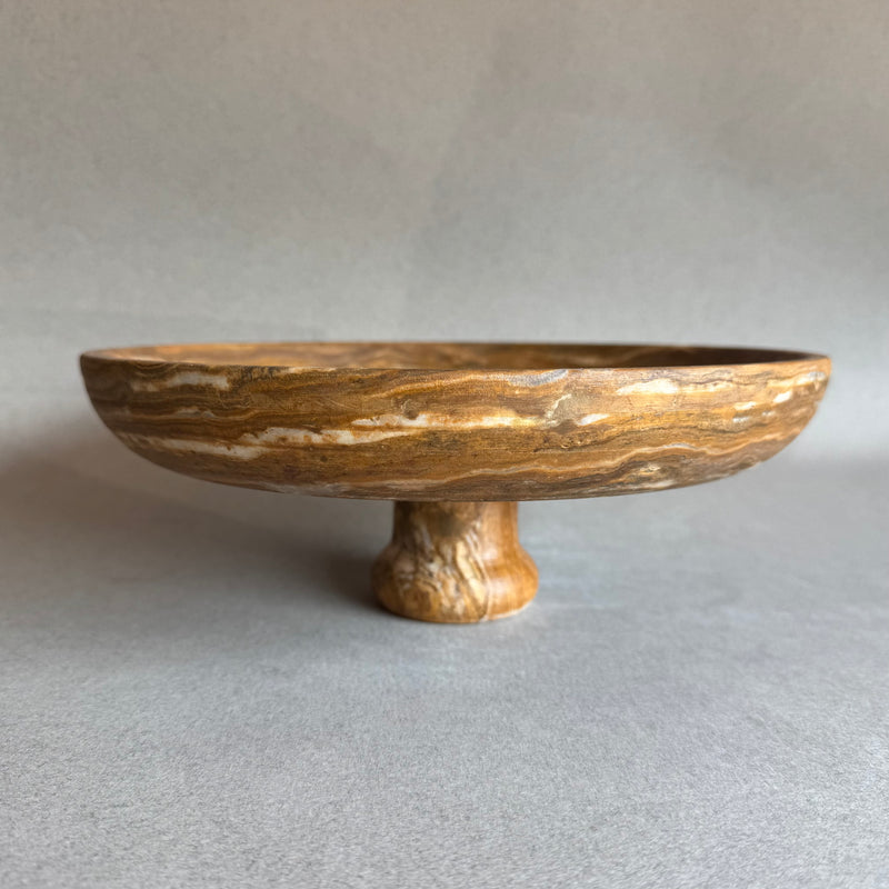Hand-carved onyx pedestal bowl in amber, honey, and sand tones