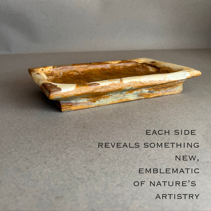 Close-up of cream and honey onyx tray highlighting organic veining and mineral texture
