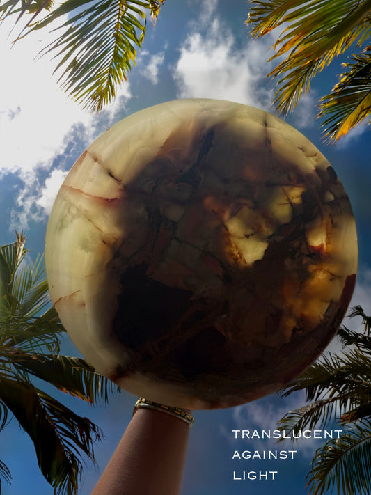 Top view of hand carved onyx pedestal bowl with swirling plum, olive green, blush, and cream veining