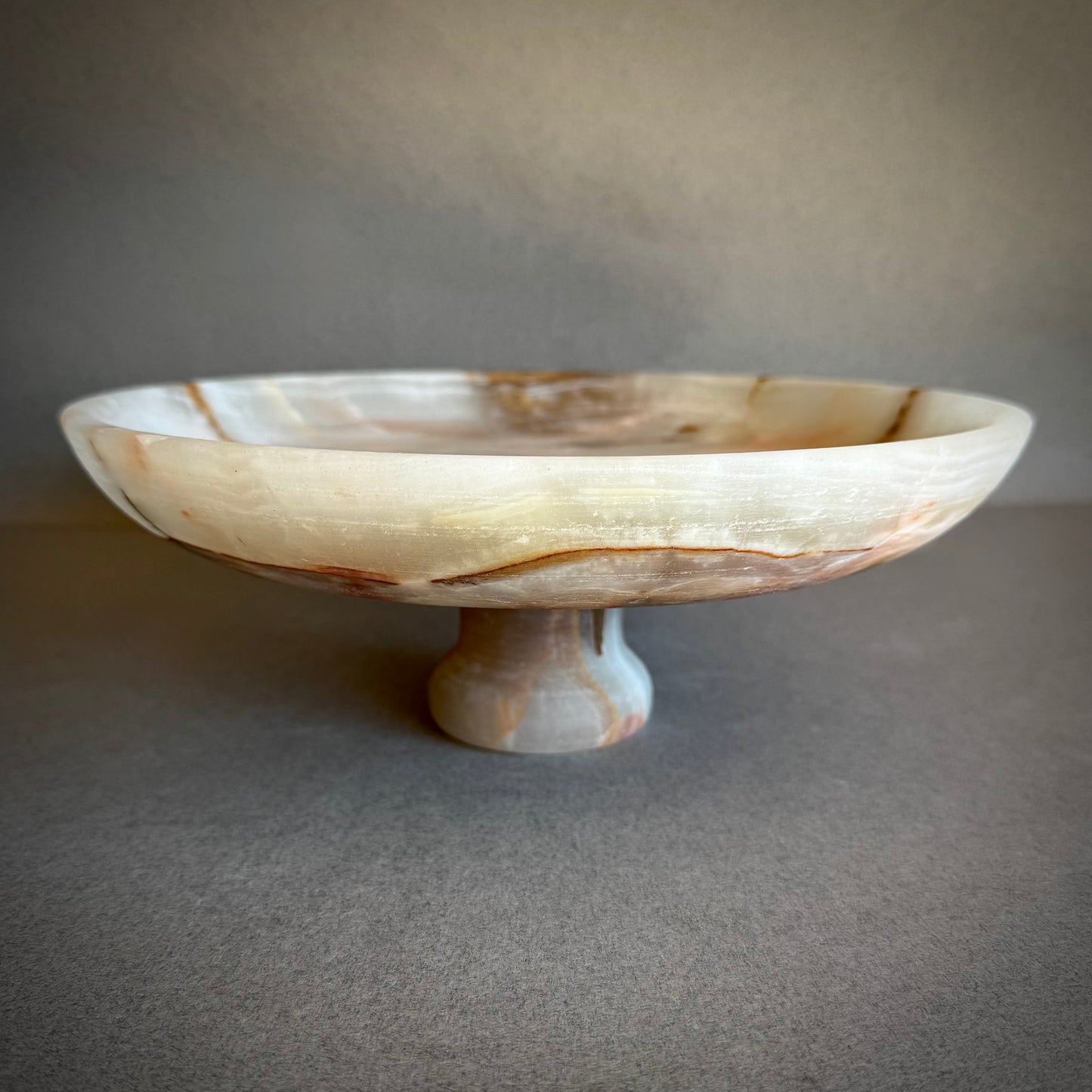 SAEA DESIGNS Decorative stone pedestal bowl against a neutral background