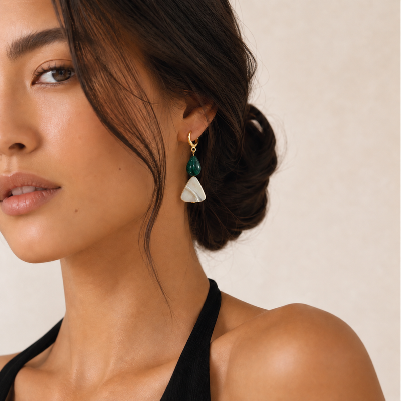 Gold-filled huggie hoops with a malachite drop and mother-of-pearl triangle, worn with hair in a low bun