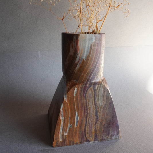 Onyx brown vase with decorative pattern on a gray background