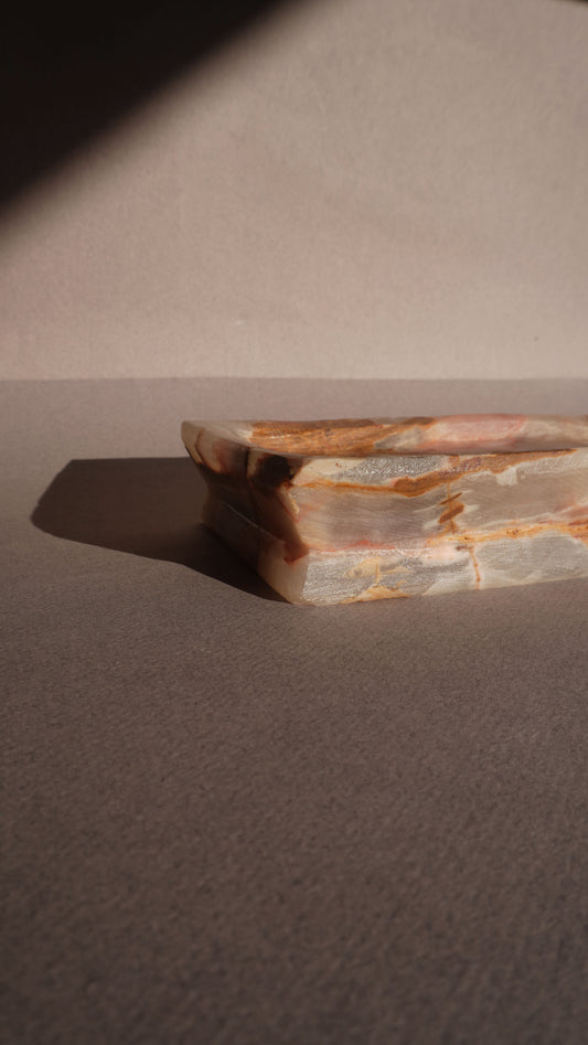 Close-up of a stone tray on a textured surface