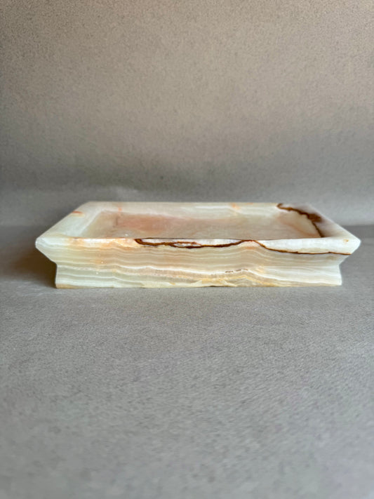 Rectangular onyx stone tray on a gray background