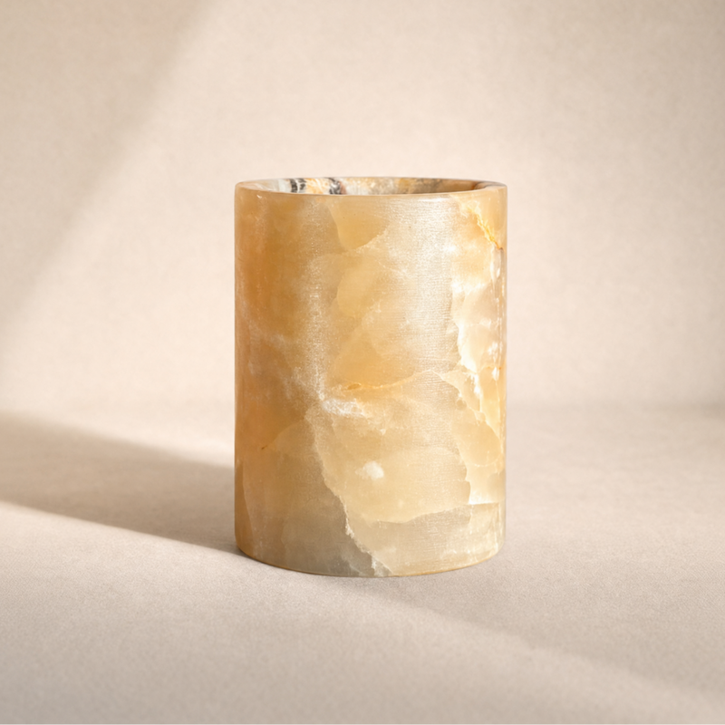 Marble-textured cylindrical jar on a neutral background