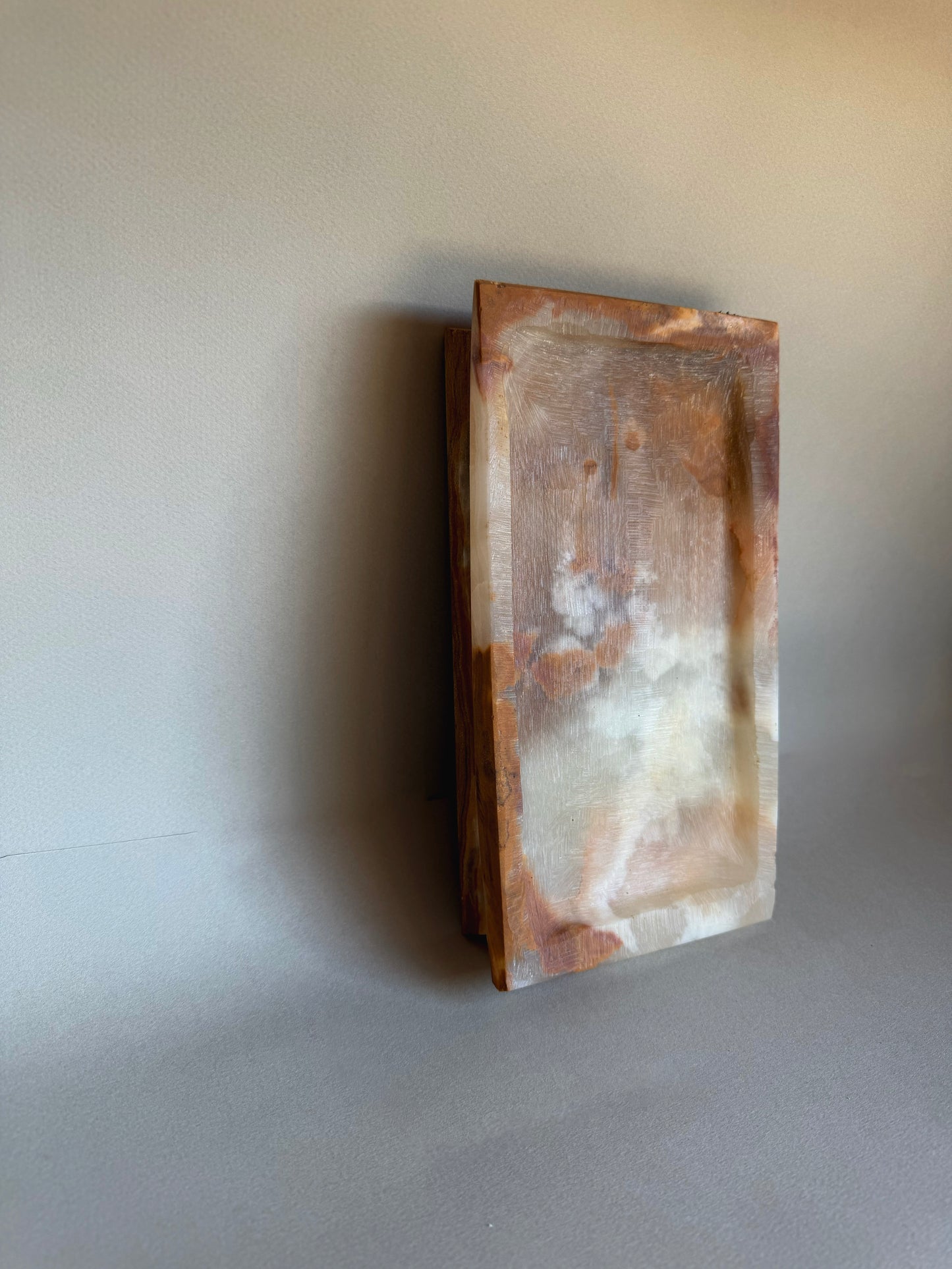 Rectangular stone object on a plain background