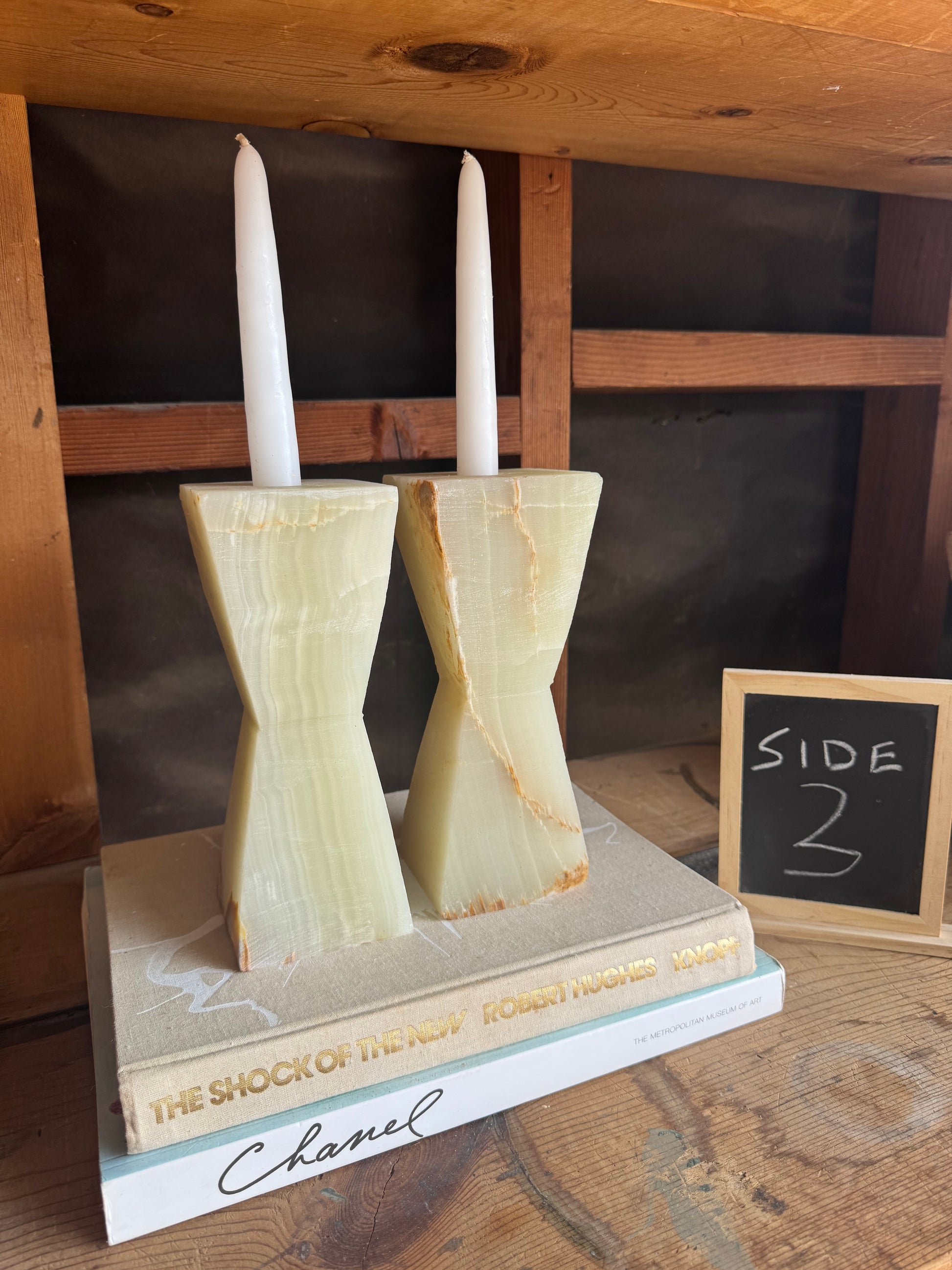 Side view of SAÉA onyx taper holders with subtle veining and rounded silhouette