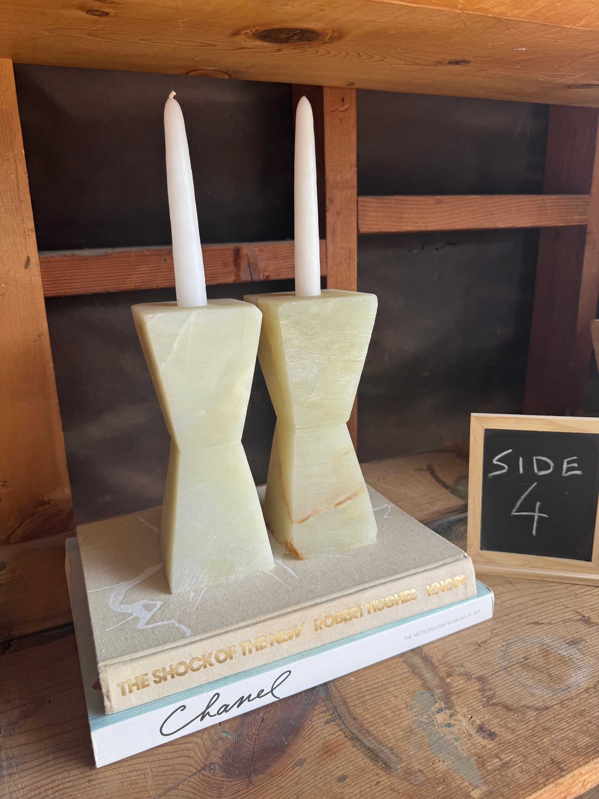 Sculptural cream and green candle holders glowing in soft light