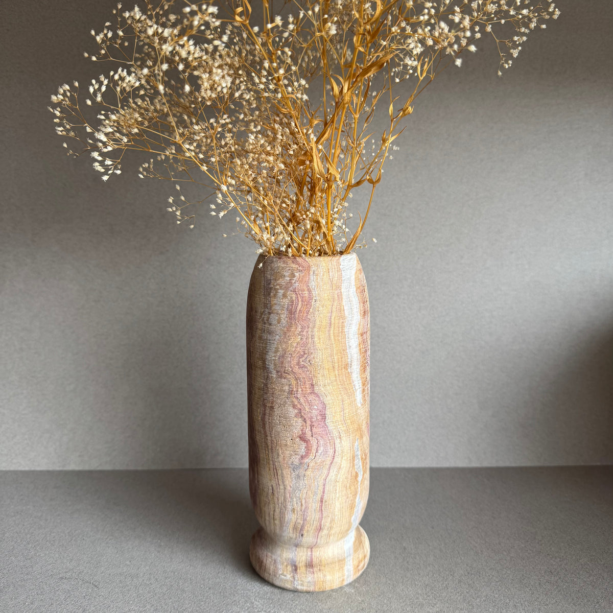 Vase styled with dried florals, highlighting organic gradient and sculptural form.