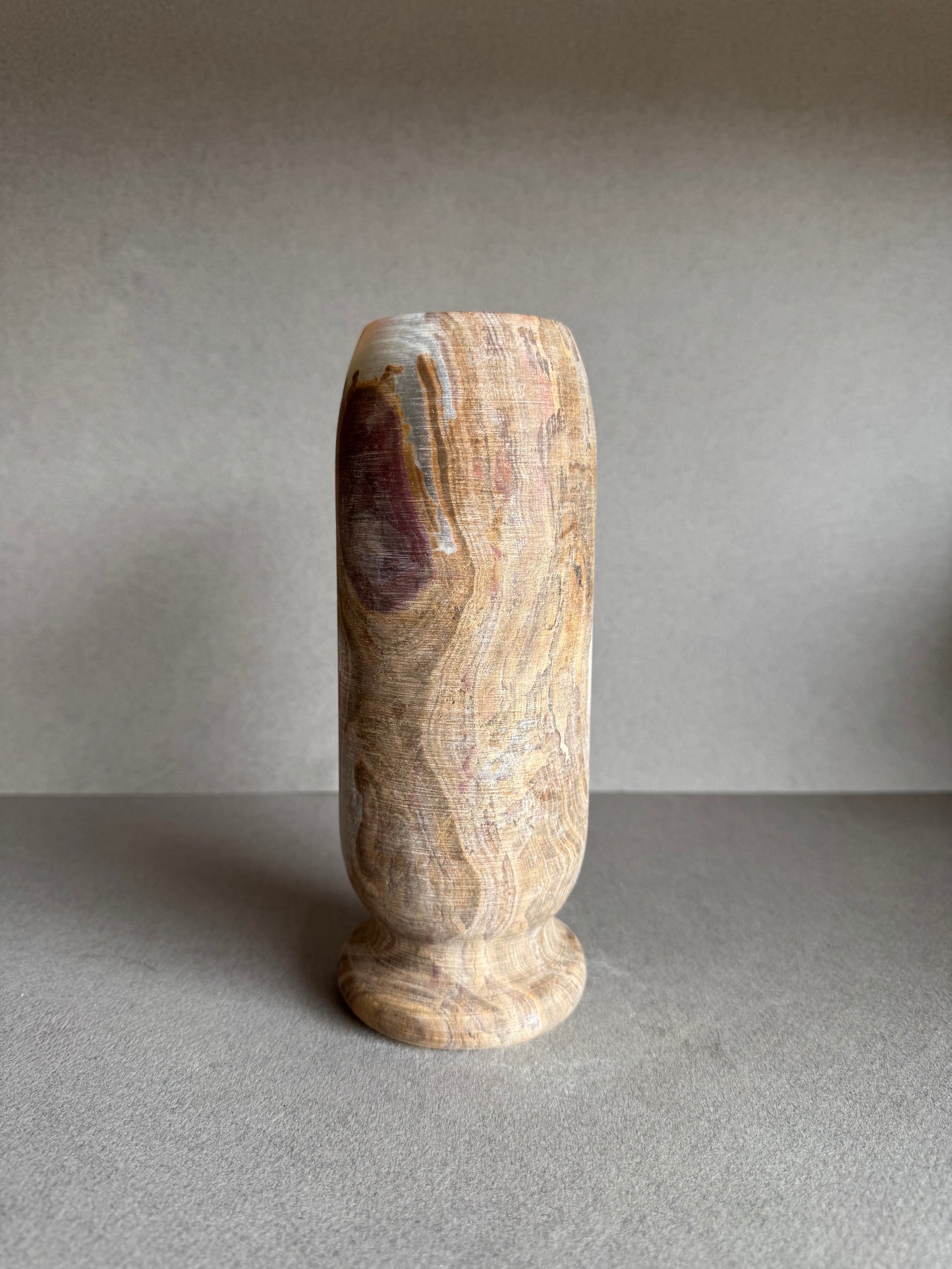 Front angle with visible marbling in soft blush and stone-white hues.