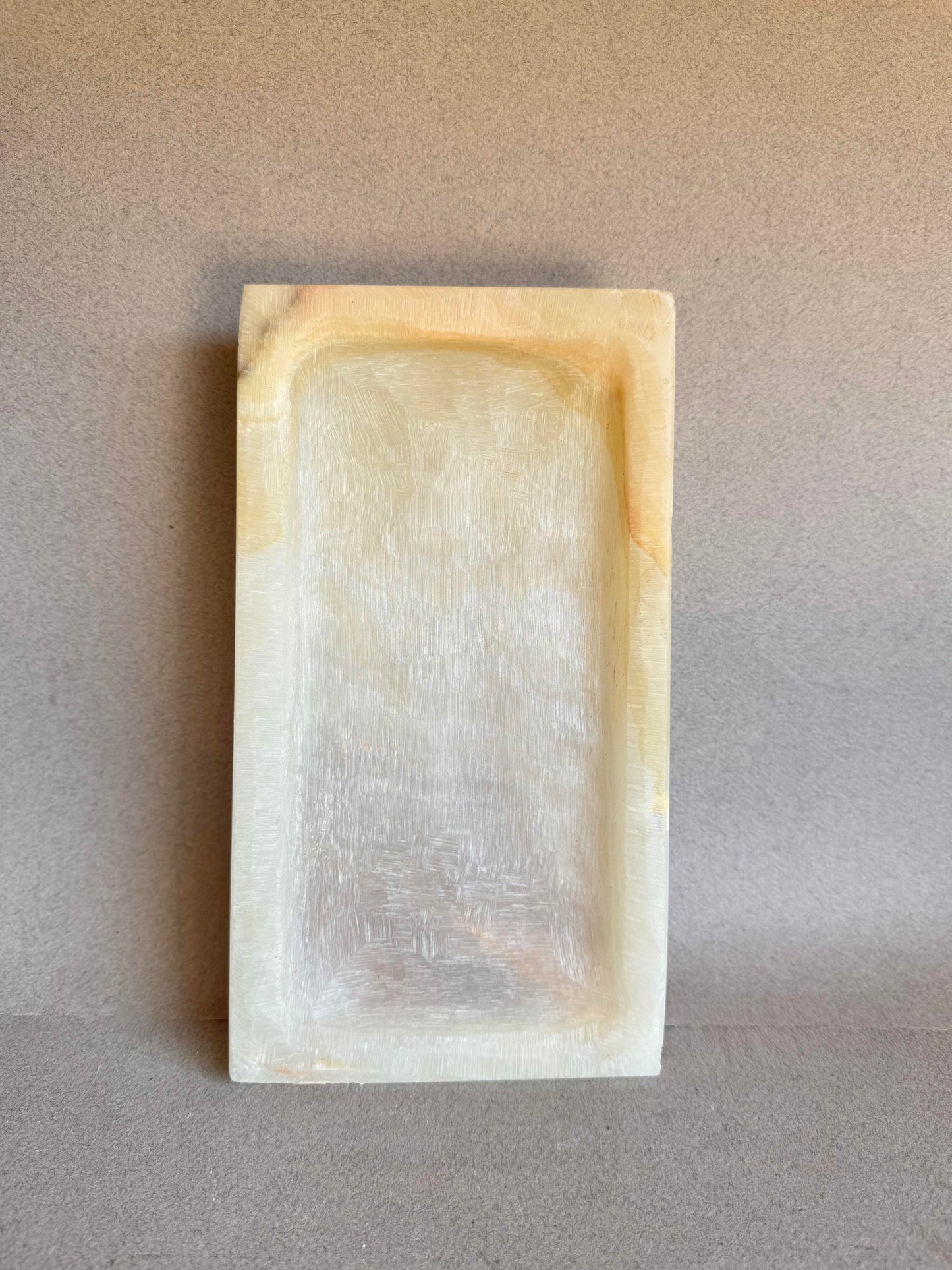 Top view of onyx catchall tray with natural honey, blush, and cream veining
