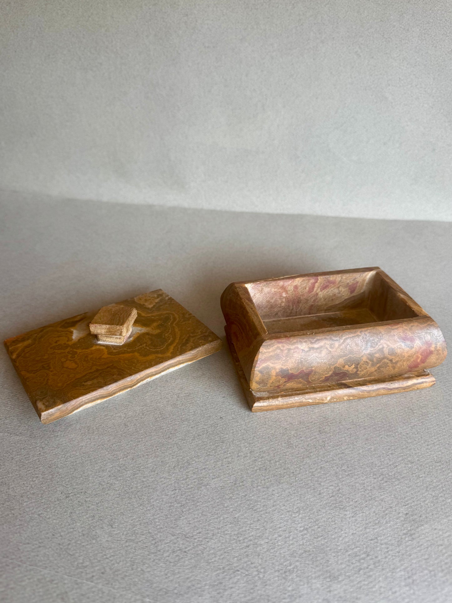 Stone container in rich ochre and rust, hand-carved and matte finished
