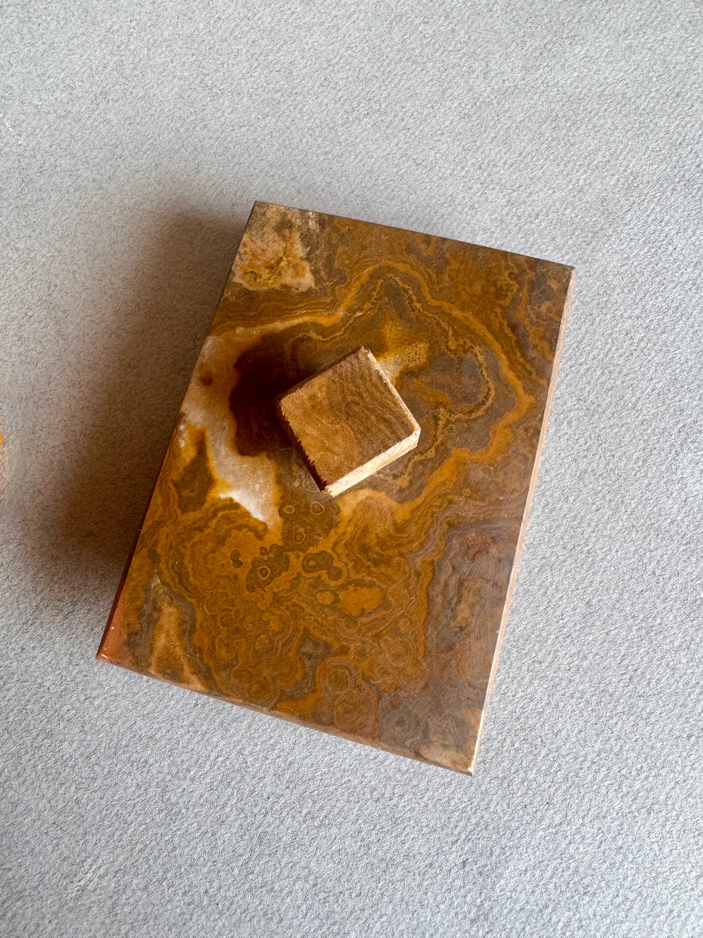 Stone container in rich ochre and rust, hand-carved and matte finished