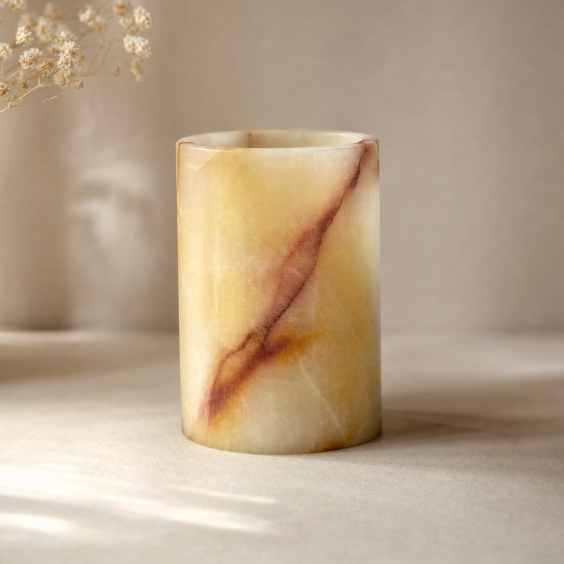 Marble-textured yellow jar on a neutral background
