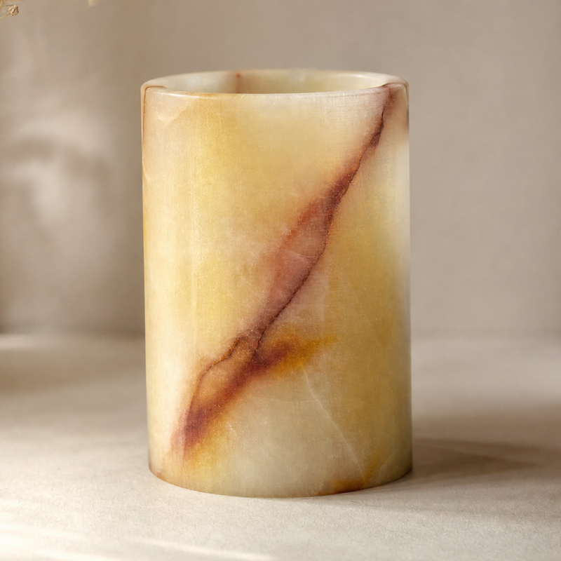 Marble-textured yellow jar on a neutral background