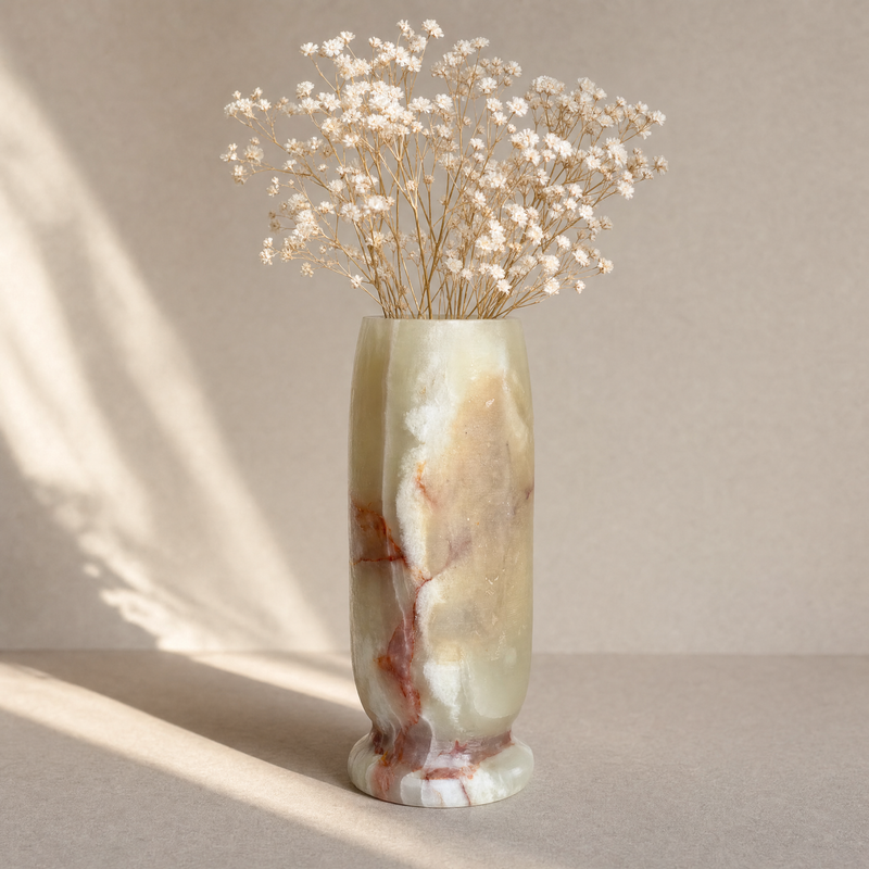 Marble-patterned vase with dried flowers on a neutral background