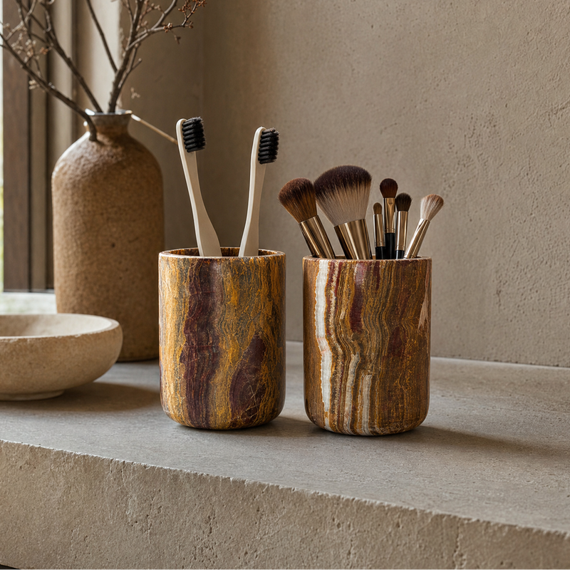 Natural onyx toothbrush and makeup brush holders in warm rust and amber tones — sustainable, plastic-free bathroom organizers.