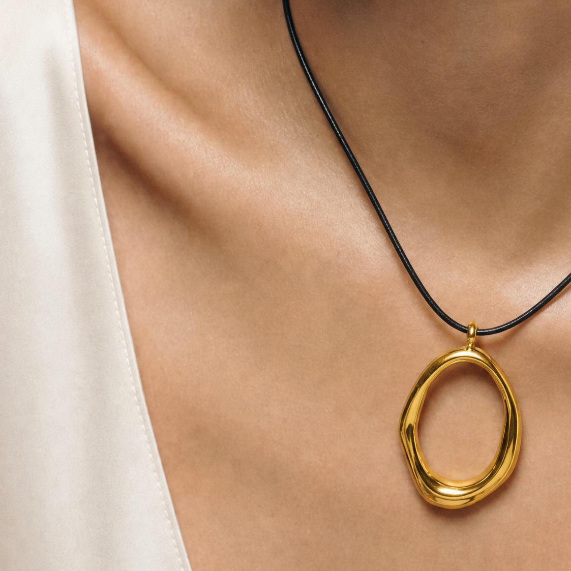 SAÉA Gold Filled Freeform Gold Oval Pendant Necklace on Black Cord