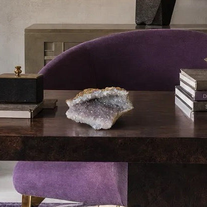 Macro view into an amethyst geode showing deep purple crystal points at the center fading to pale lilac and white toward the rim.