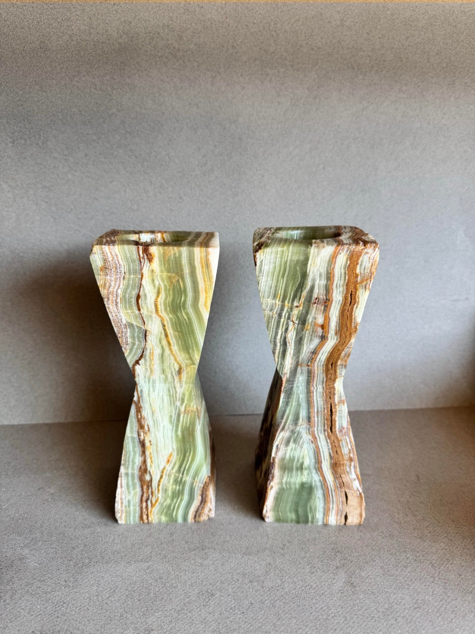 Hand-carved green onyx tealight holders in sculptural hourglass form