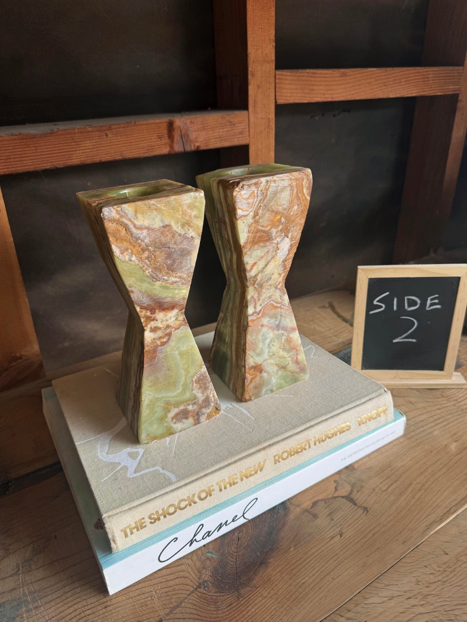 Side view of green onyx candle holders with marbled veining and tapered shape