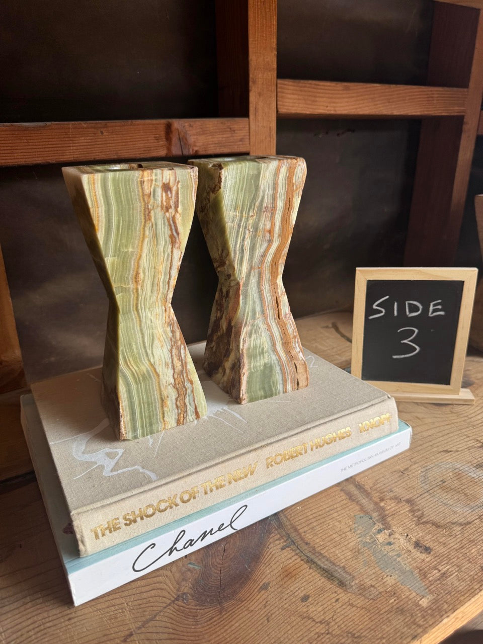 Close-up of sculptural hourglass candle holders in translucent Pakistani onyx