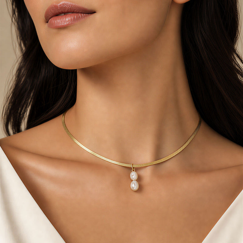 Double freshwater pearl pendant choker necklace on model, 18K gold flat herringbone chain, 14 inch waterproof tarnish-resistant stainless steel, SAÉA