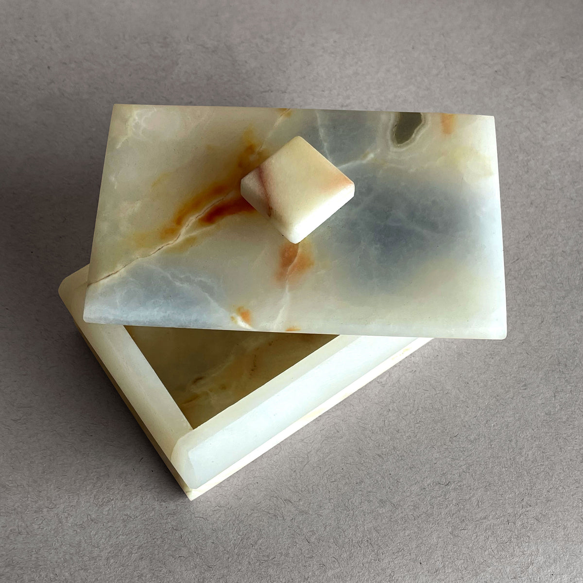 Marble-patterned jewelry box with on a gray background