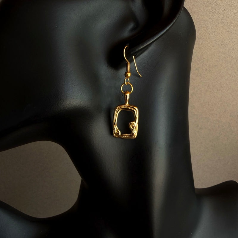 Handmade gold sculptural drop earrings worn on black display bust, 14k gold filled statement earrings, minimalist artisan jewelry