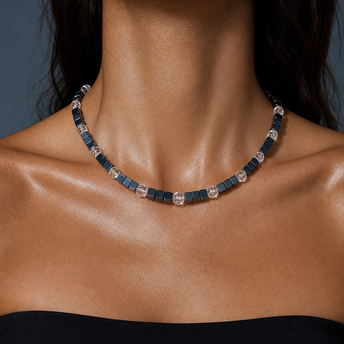 Model wearing a vintage hematite cube bead necklace, gunmetal square beads with clear faceted crystal rounds at the collarbone