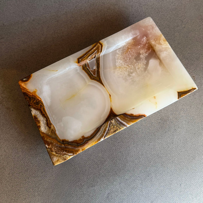 Hand-carved ivory and honey onyx catchall tray with translucent natural stone, raw polish-free onyx vanity tray styled with jewelry and perfume