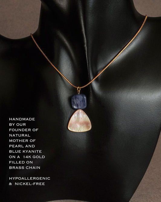 Iridescent mother of pearl pendant with natural blue kyanite gemstone on gold filled chain close up