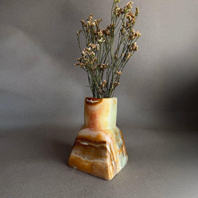 Close up of raw onyx vase highlighting organic veining, mineral layers, and natural stone texture