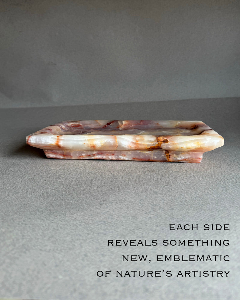 Top view of hand carved onyx tray showing soft purple and blush stone pattern