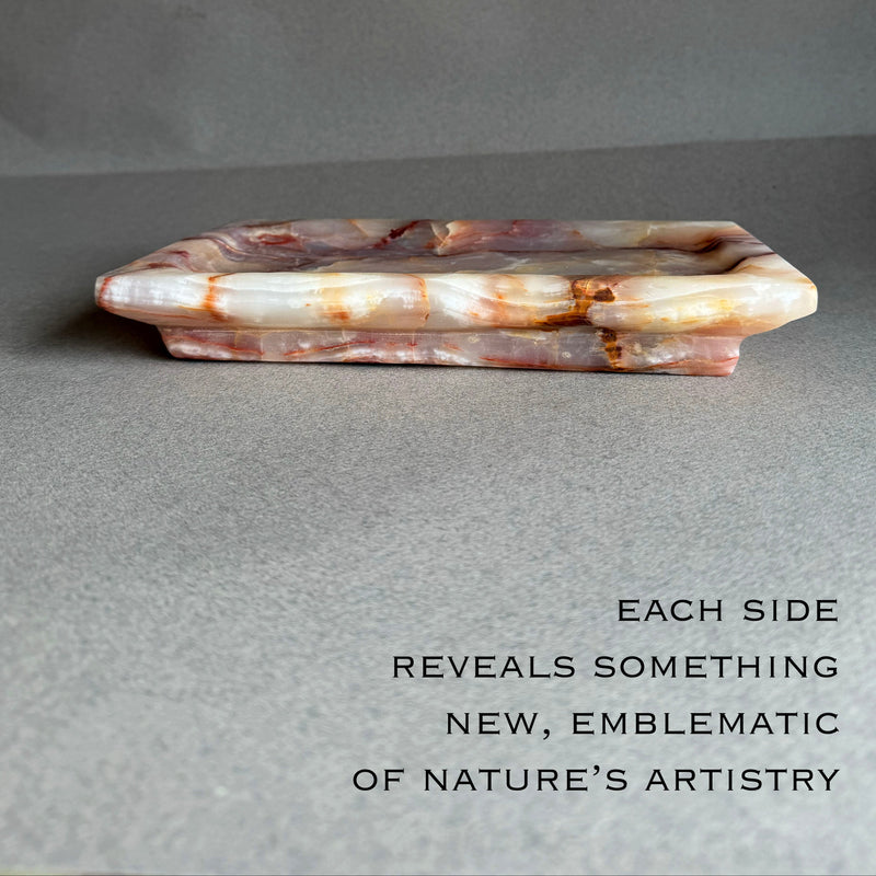 Top view of hand carved onyx tray showing soft purple and blush stone pattern