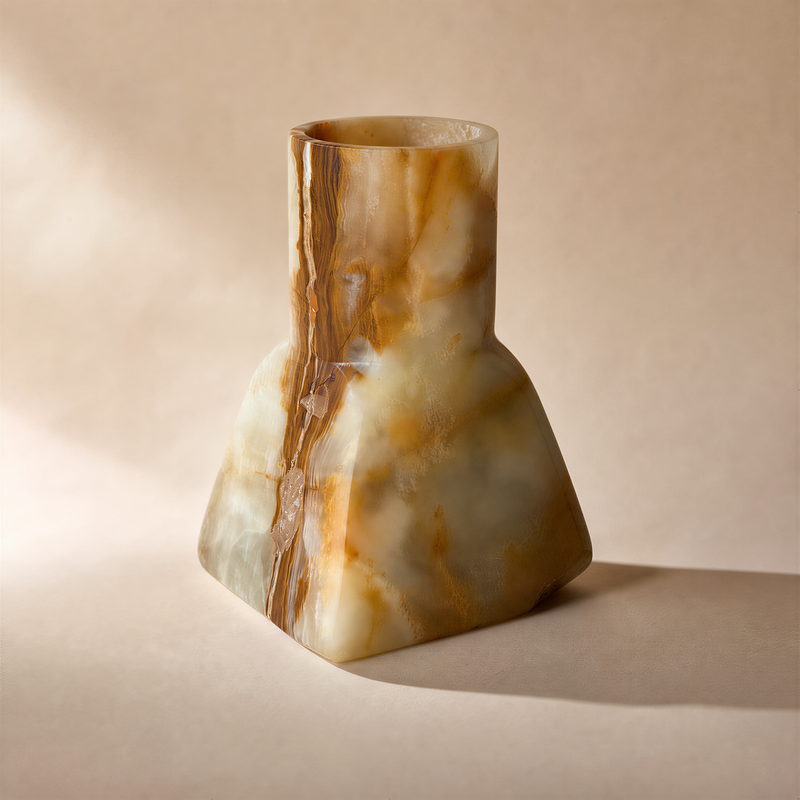 Marble-like onyx vase with brown and beige patterns on a beige background