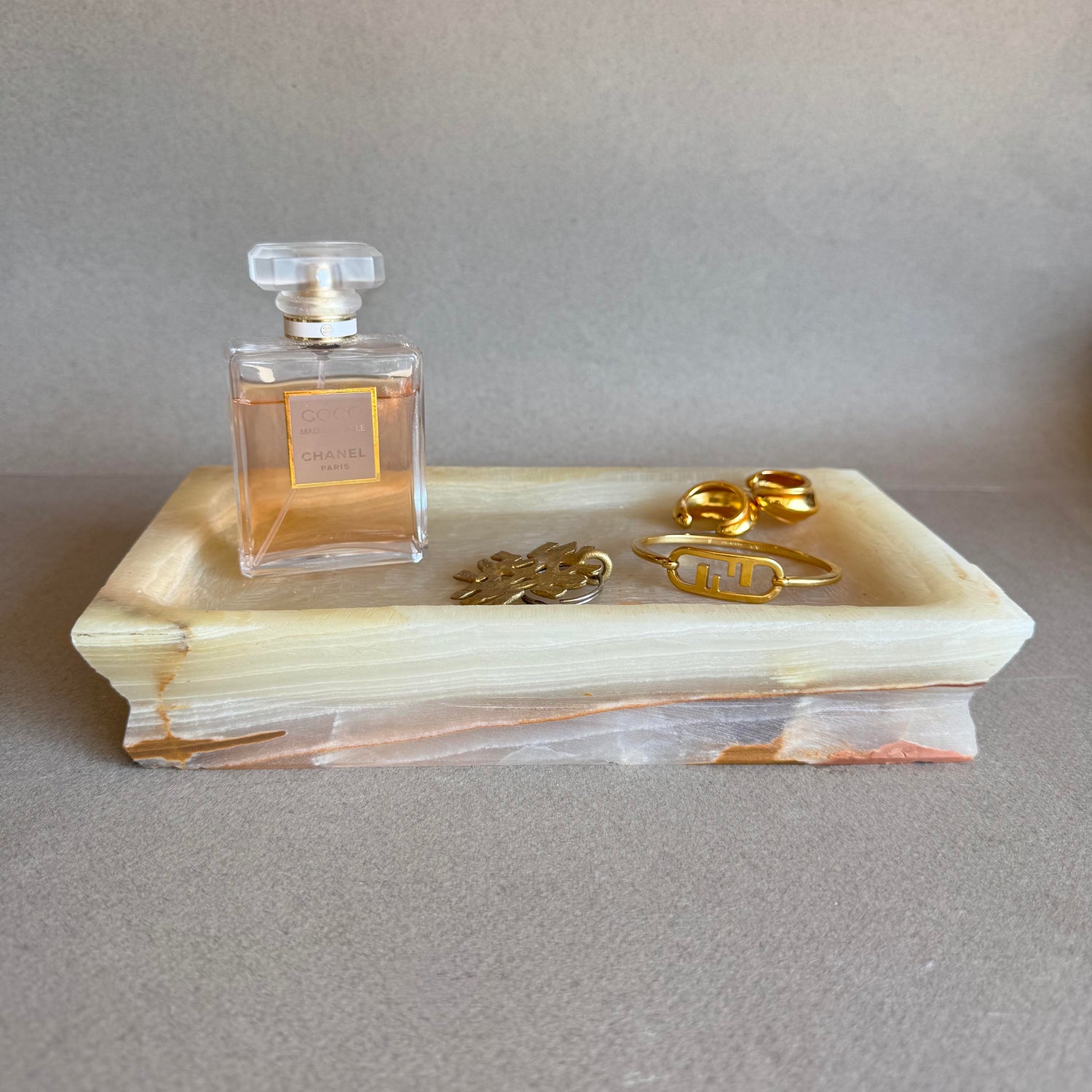 Hand-carved onyx catchall trays for jewelry, candles, or decor. Each piece is unique, plastic-free, and finished in San Diego with sustainable care.