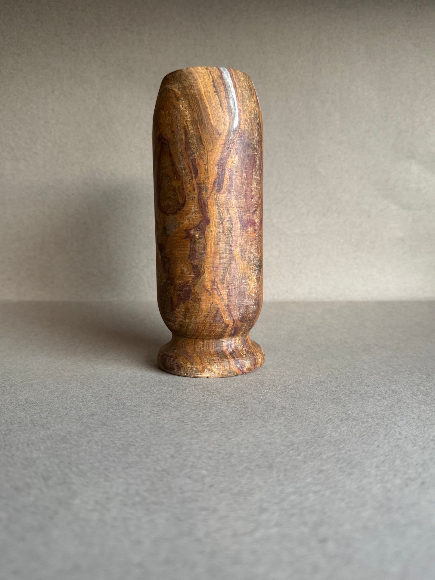 Plum and rust-colored vase showing raw mineral texture