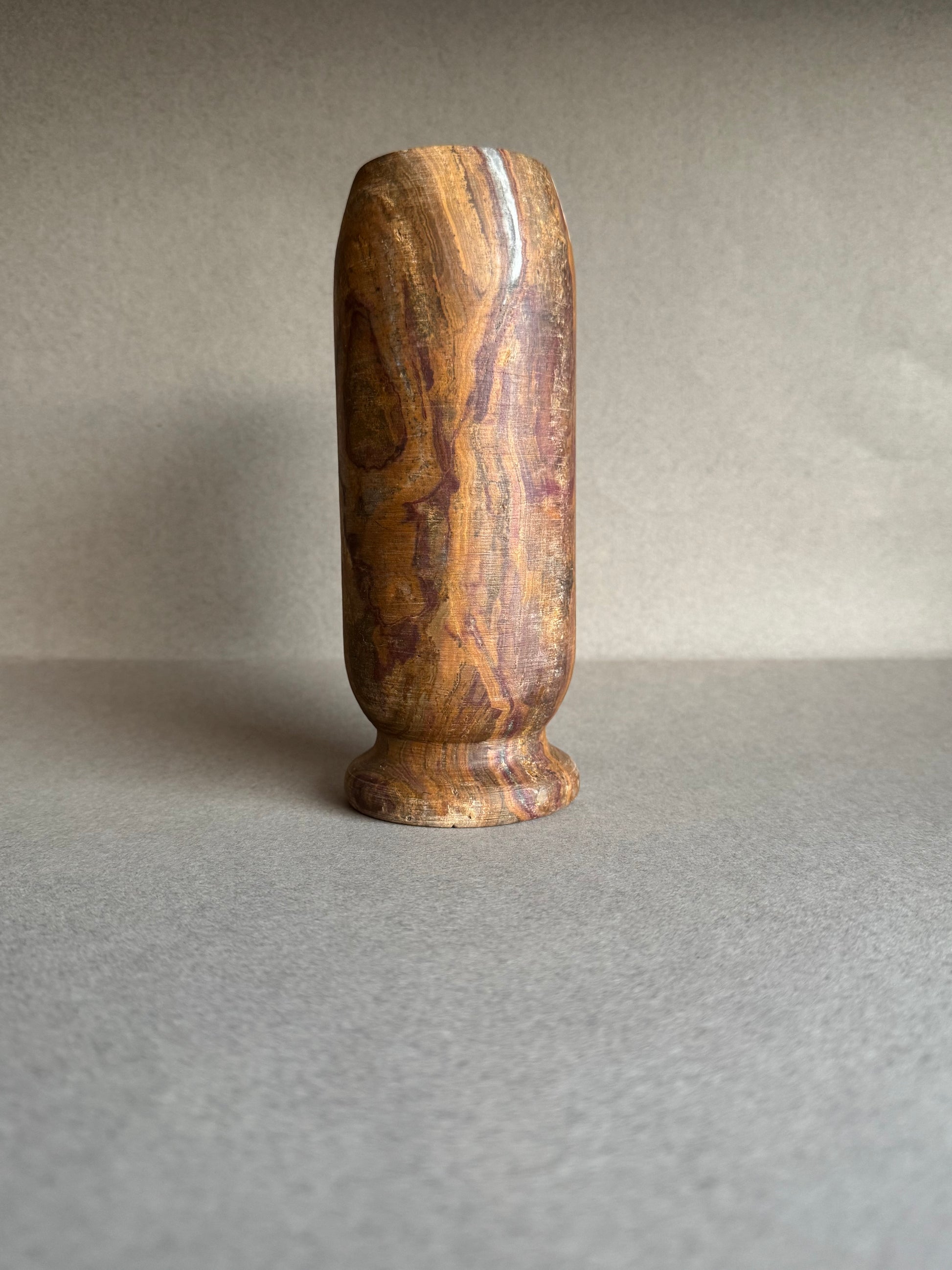 Plum and rust-colored vase showing raw mineral texture