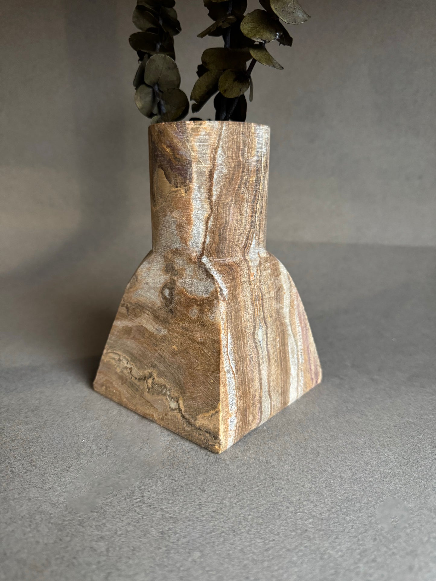 Decorative vase with a natural stone pattern on a gray background