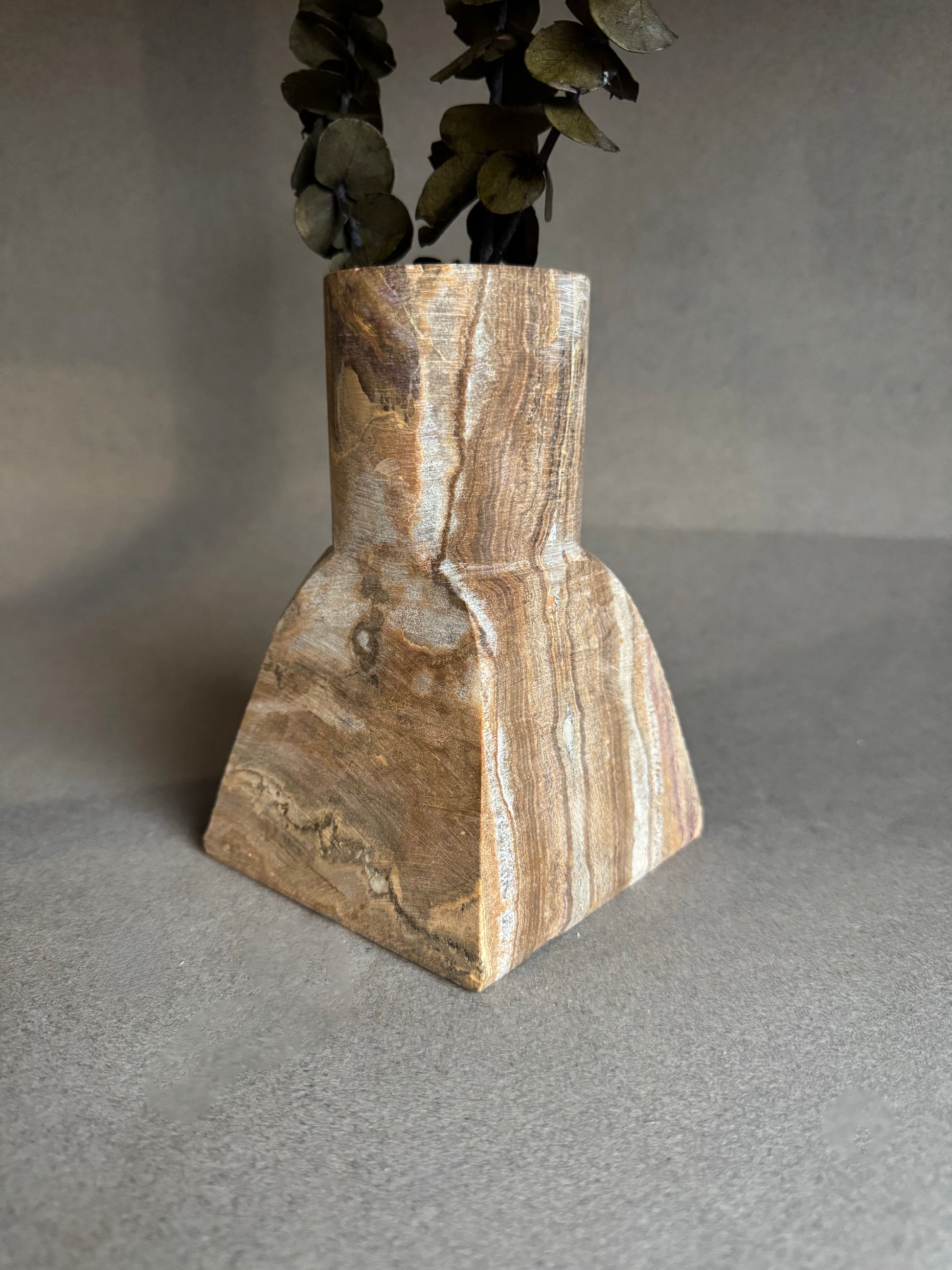Decorative vase with a natural stone pattern on a gray background