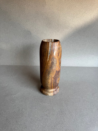 Cylindrical stone vase in earthy espresso and sienna layers

