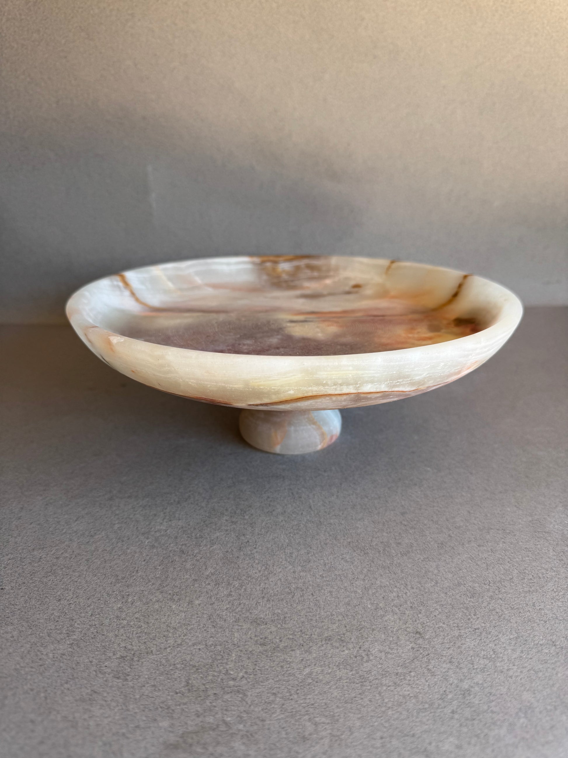 Natural onyx pedestal bowl, hand-carved in Pakistan and finished in California. Unique stone centerpiece or fruit bowl—ideal wedding or housewarming gift.