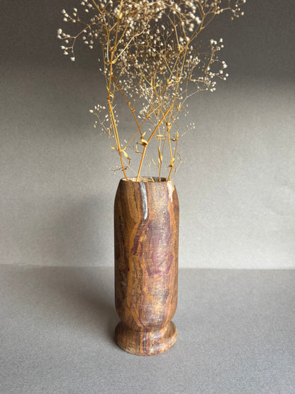 Hand-carved onyx vase in ochre, clay, and plum tones with dried florals