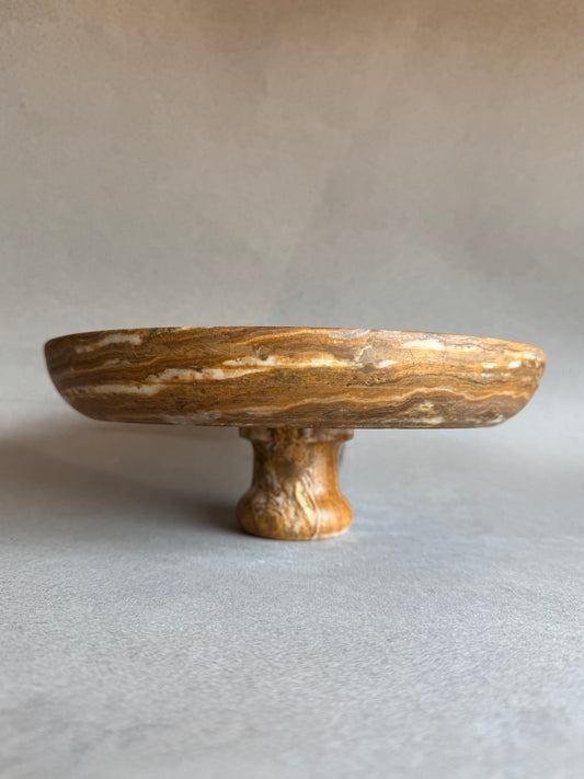 Natural stone fruit bowl with warm golden brown veining

