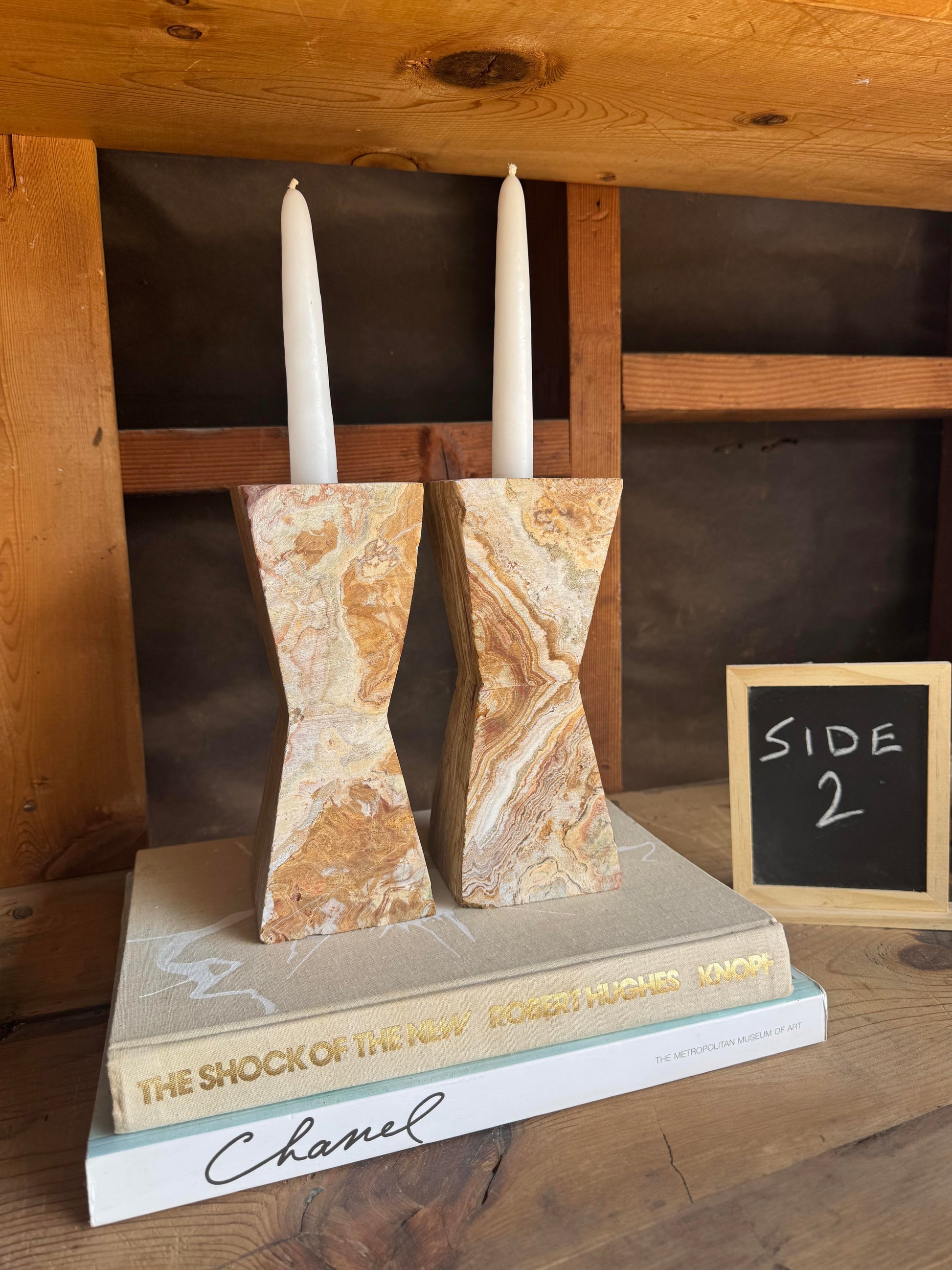 Front view of terracotta hourglass candle holders with sandstone marbling


