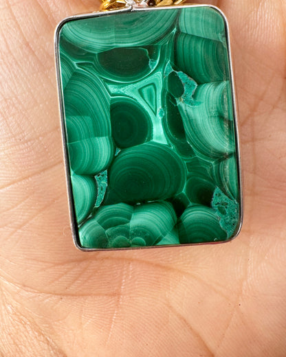 green Malachite pendant on a hand