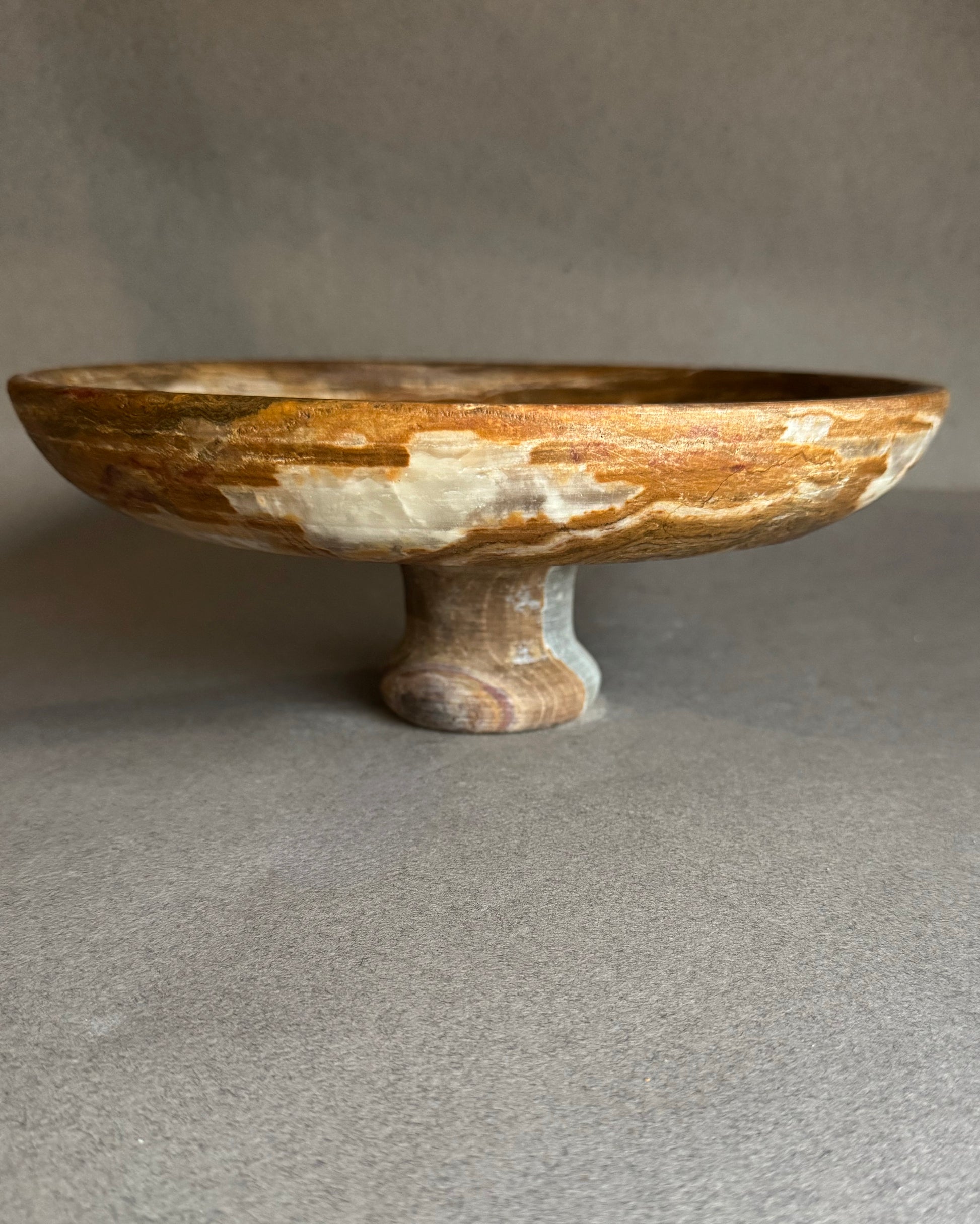 Decorative stone bowl on a gray background