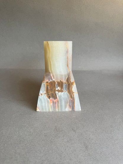 Marble-patterned stone vase on a gray background
