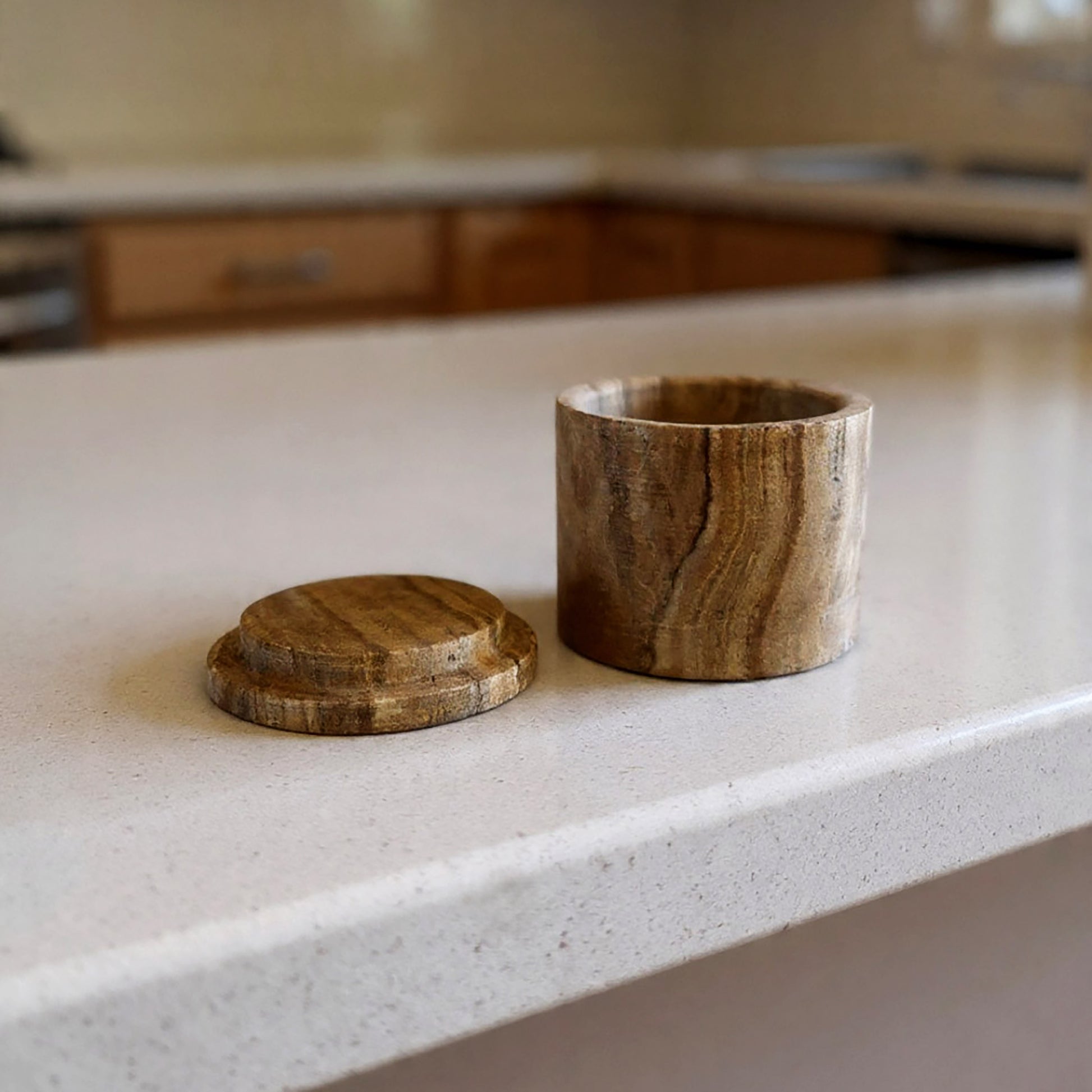 Wooden container with lid on a kitchen counter